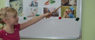 A girl points with a pointer at pictures on a magnetic board